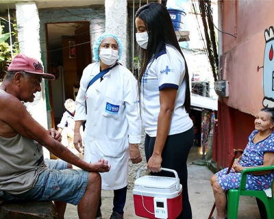 COVID-19 Vaccinators talk with residents in Rio de Janeiro, Brazil