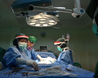 An obstetric team performs a caesarean section delivery at the RSIA Tambak maternity clinic in Jakarta, Indonesia, May 10, 2020.